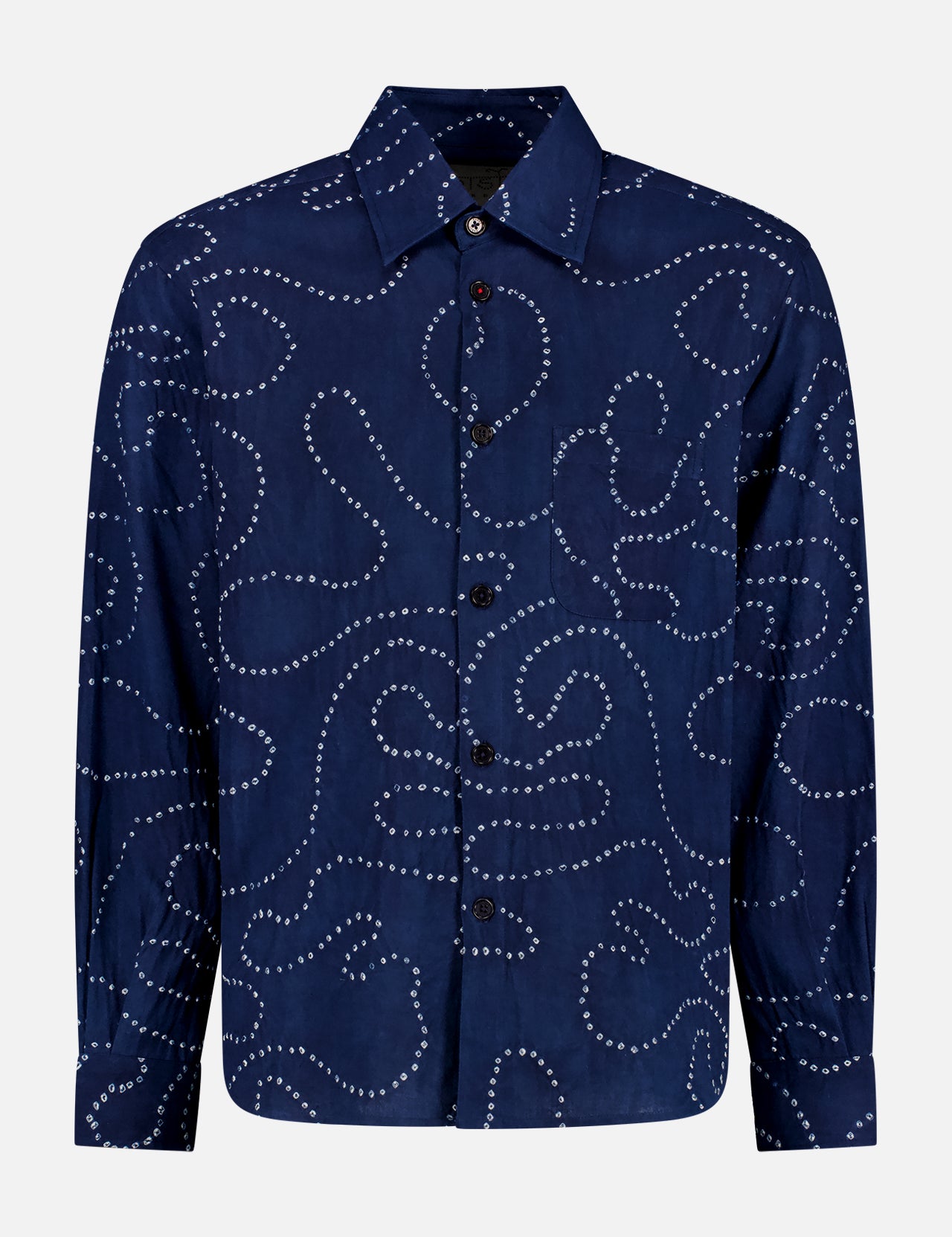 The Luis Shirt by KARDO is a long-sleeved, oversized dark blue indigo shirt with a collar, featuring white dotted swirls and curves across the fabric.