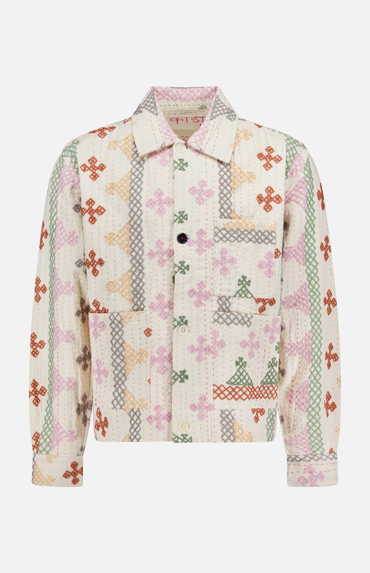 The KARDO Bodhi Shirt Jacket is a long-sleeve, collared jacket made in India from 100% cotton. It features a front pocket, quilted texture, and multicolored floral and geometric patchwork on a white background.