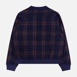 A back view of the KARDO Janesh Quilted Plaid Cardigan in navy blue, showcasing long sleeves with ribbed cuffs and a waistband. The cozy men’s cardigan features a quilted design with a plaid pattern of thin red and tan lines against a dark blue background, making it ideal for layering during cooler weather.
