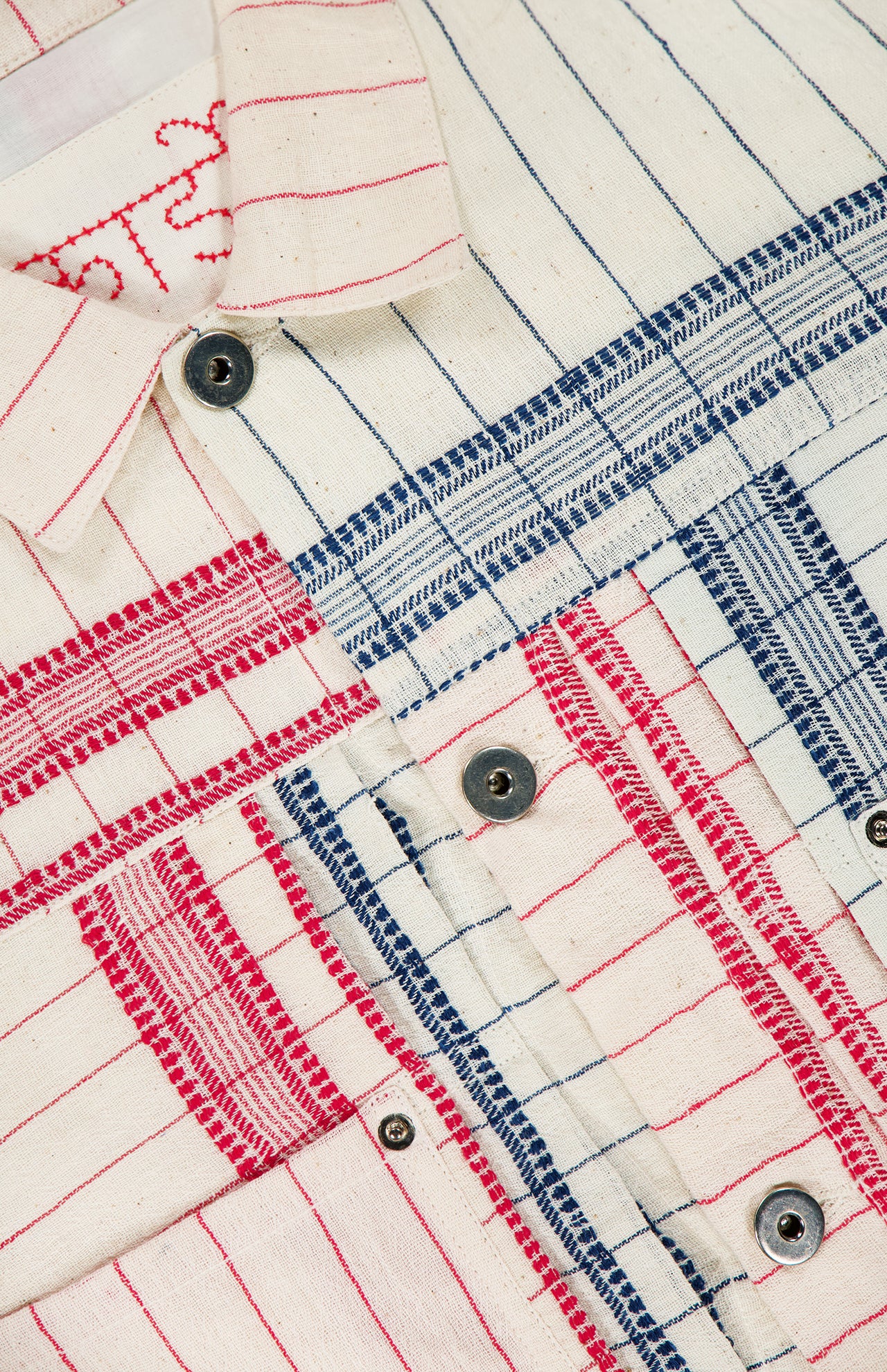 Close-up of the KARDO Marvin Cotton Overshirt featuring textured fabric with red and blue stripes, metal buttons, and visible stitching—ideal for Memorial Day layering.