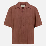 The KARDO Rohit Stripe Short Sleeve Shirt is a brown, 100% cotton, oversized button-up with a chest pocket, collar, and subtle textured stripes. Displayed on a plain white background.