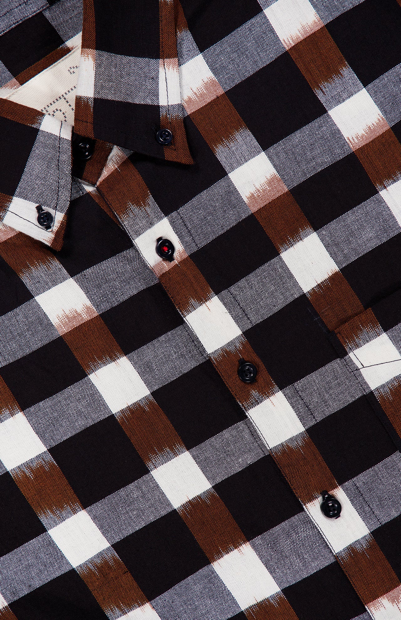 Close-up of the KARDO Ronald Checkered Long Sleeve Shirt, featuring a black, white, and brown plaid pattern. Made from 100% cotton, this shirt showcases black buttons and a visible collar.