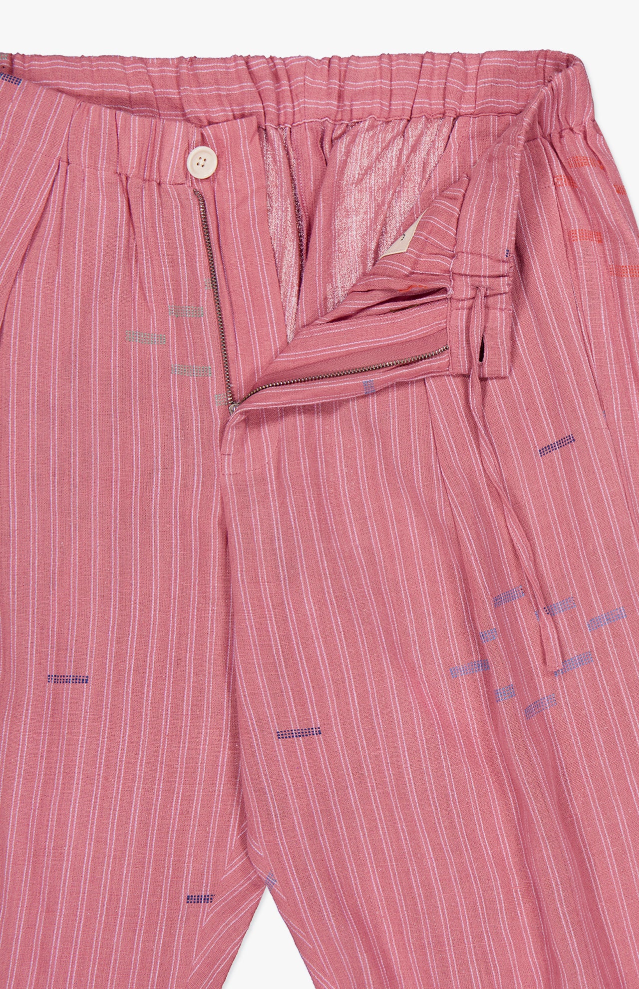 The Taka Striped Trouser Pants by KARDO feature a relaxed fit in soft embroidered cotton with thin white stripes, scattered colorful stitches, an elastic back waistband, partially open zip fly, and a cream button.