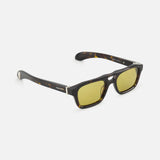 Alexander McQueen Pilot Brown Sunglasses by ALEXANDER MCQUEEN feature a rectangular dark brown tortoiseshell frame with yellow-tinted lenses and silver accents, shown against a plain white background.