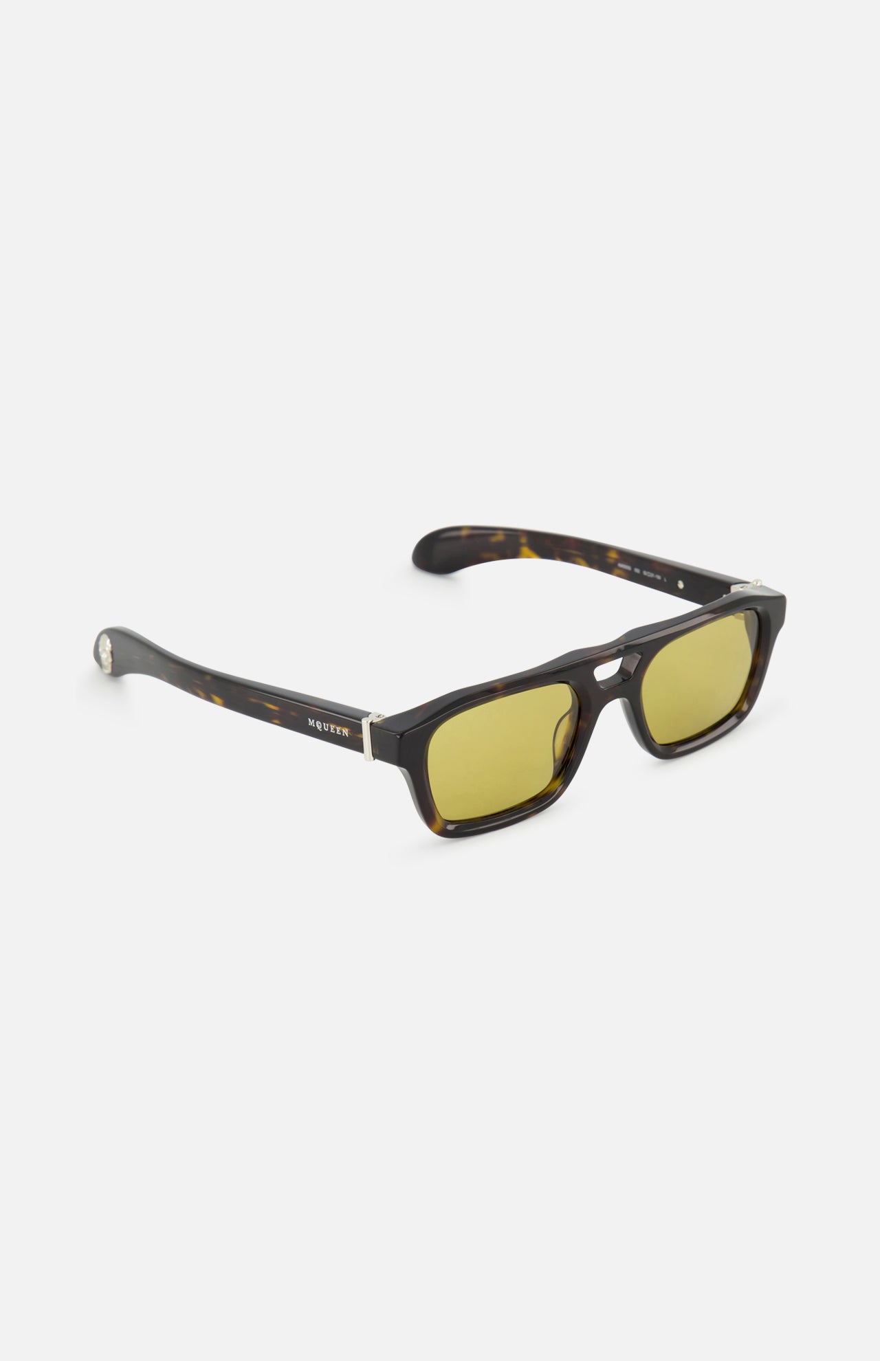 Alexander McQueen Pilot Brown Sunglasses by ALEXANDER MCQUEEN feature a rectangular dark brown tortoiseshell frame with yellow-tinted lenses and silver accents, shown against a plain white background.