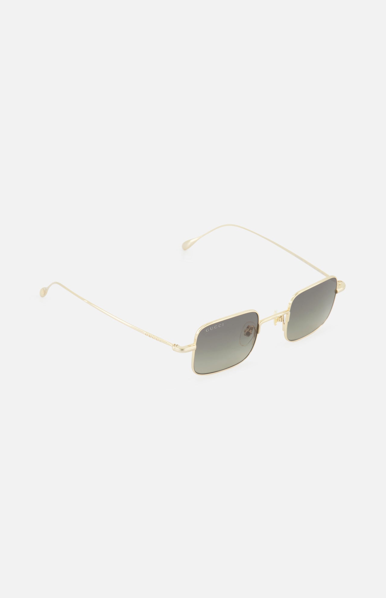 The GUCCI Square Gold Sunglasses feature thin metal frames and dark tinted lenses. Shown on a white background, these unisex sunglasses have delicate arms with rounded ends for a sleek, modern look.