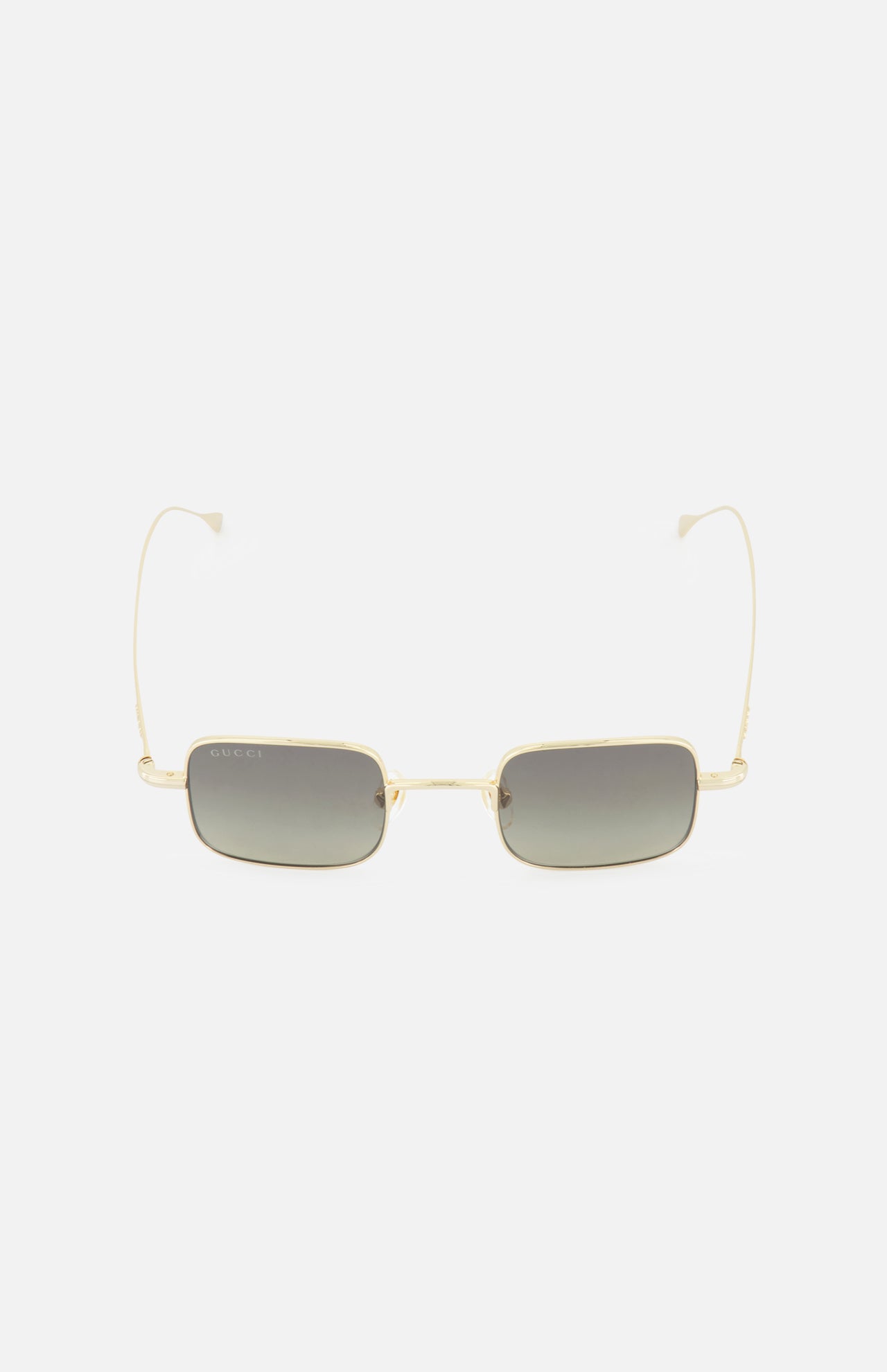 The GUCCI Square Gold Sunglasses feature a gold frame, dark tinted lenses, and thin metal arms. These unisex Gucci sunglasses are showcased against a plain white background.