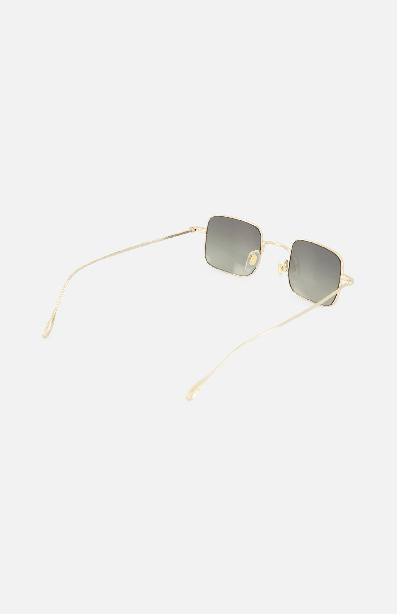 The GUCCI Square Gold Sunglasses feature thin gold metal frames and gray tinted lenses. Shown angled on a white background, these unisex shades have long, slender temples and clear nose pads.