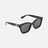 Gucci Round Black Sunglasses by GUCCI feature dark green lenses and gold GG logo details on the temples, shown here against a plain white background.