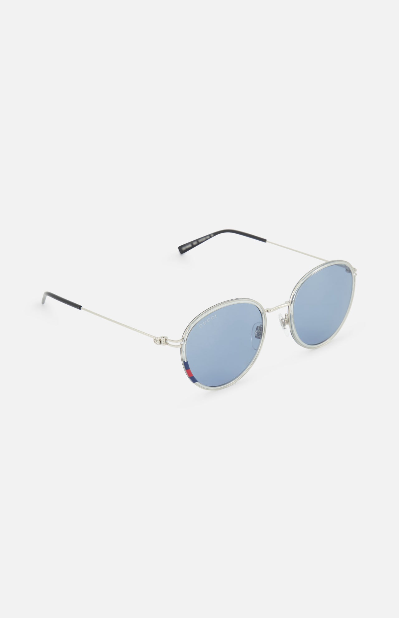 The Gucci Round Silver Sunglasses by GUCCI feature silver frames, light blue lenses, and black-tipped arms for a stylish unisex look, shown on a plain white background.