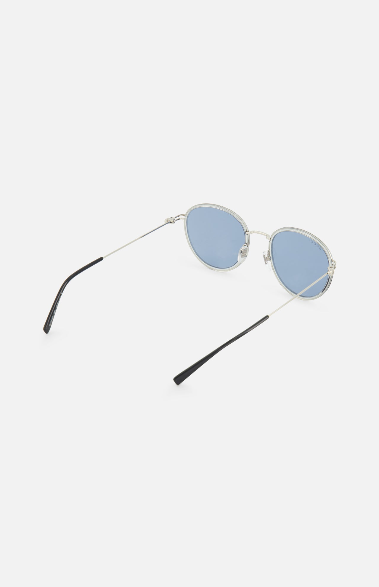 GUCCI Round Silver Sunglasses: Unisex design with blue-tinted round lenses, thin silver temples, and black tips, shown against a white background.
