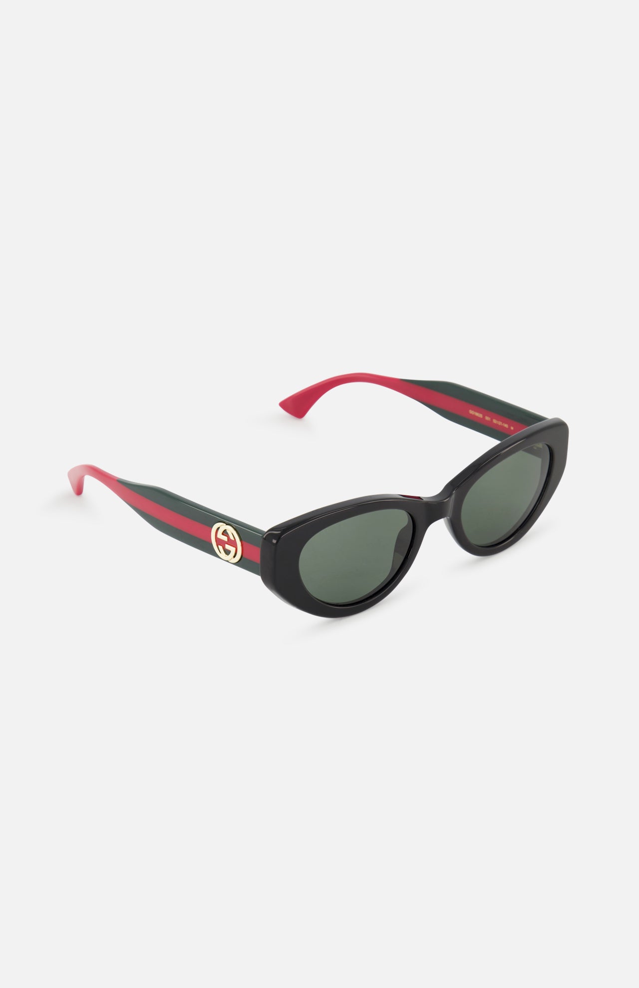 GUCCI Cat Eye Black Sunglasses with green lenses, red and black arms, gold Gucci logo on the temple, and red interior arms are displayed on a white background.