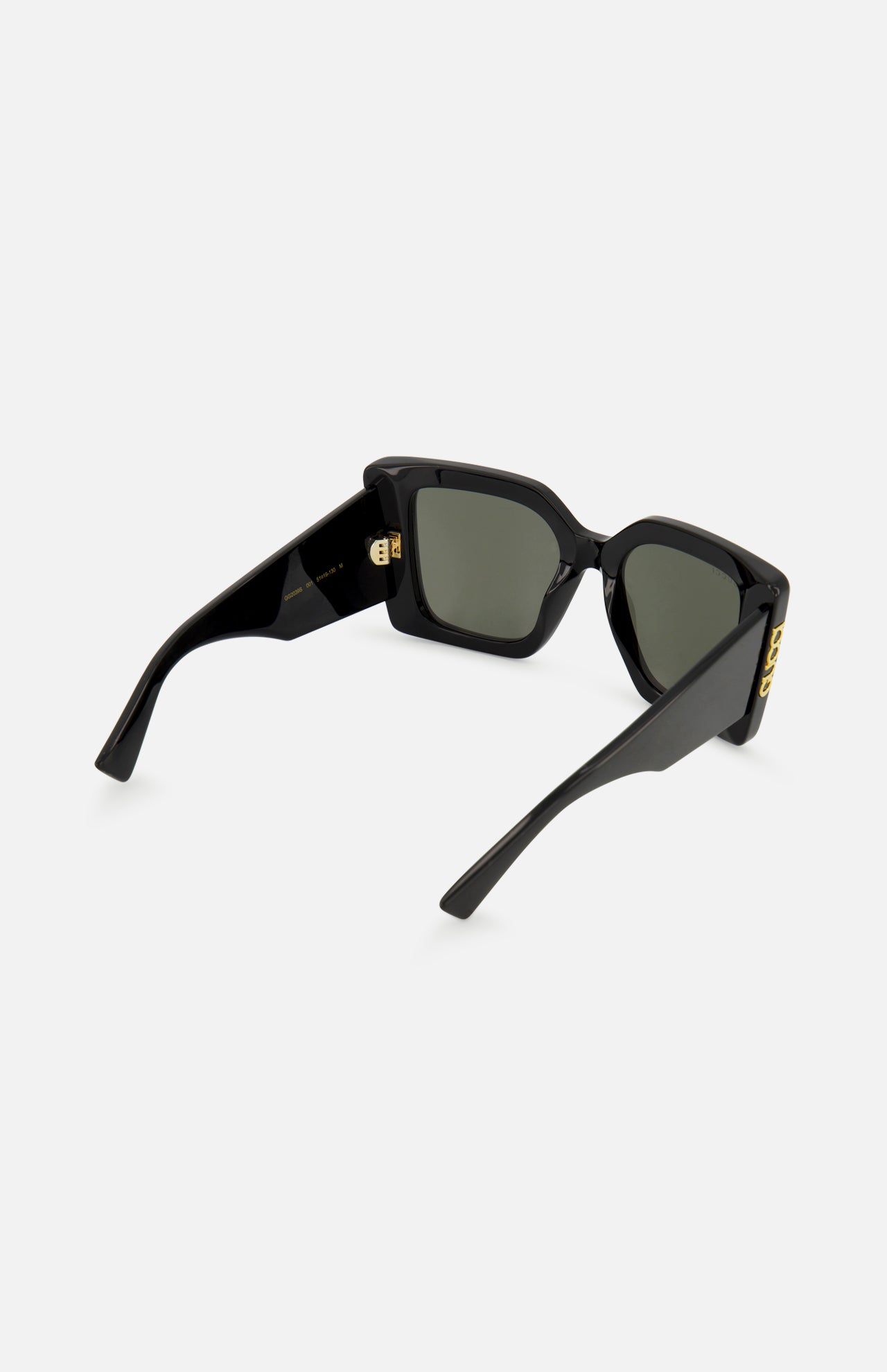 GUCCI Butterfly Black Sunglasses with retro-inspired thick frames, green-tinted lenses, and gold-tone temple accents are shown from a rear three-quarter angle against a plain white background.