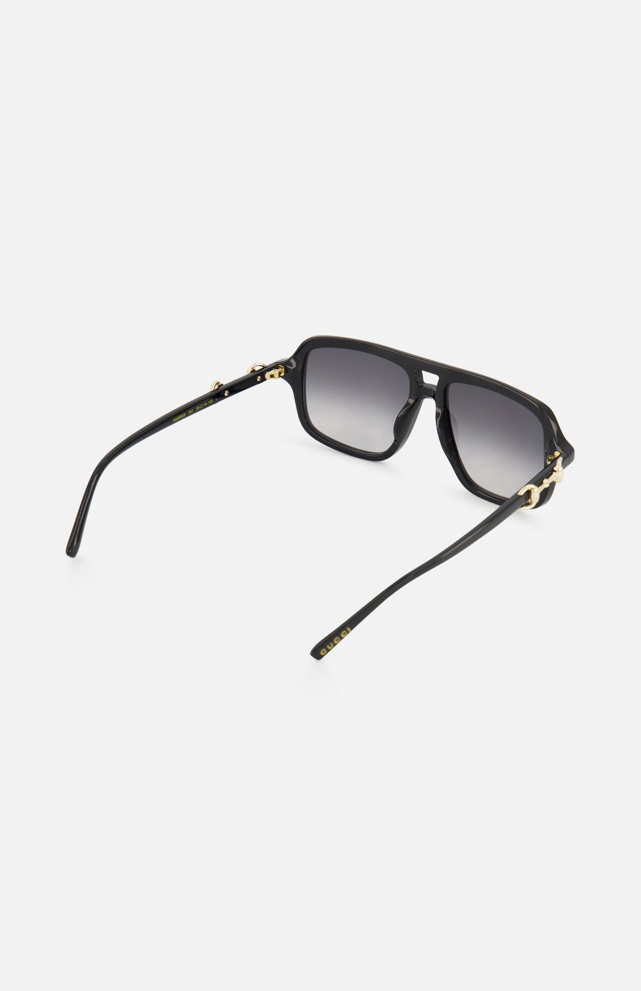 Gucci Aviator Black Sunglasses by GUCCI shown on a white background, featuring gradient grey lenses, gold-tone horsebit detail on the temples, and curved arms.