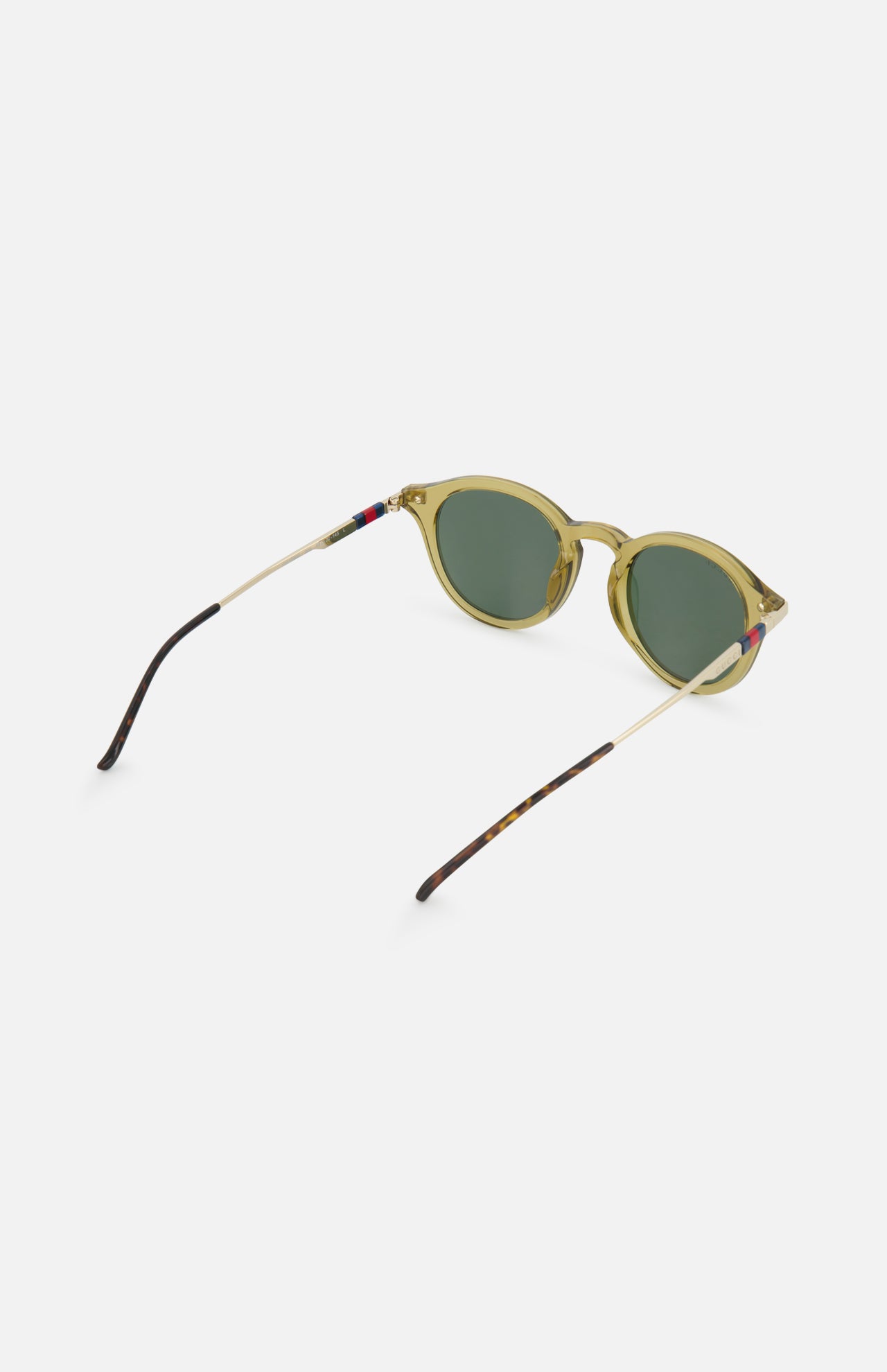 Gucci Round Brown Sunglasses by GUCCI feature green round frames, thin gold arms with dark ends, and red-blue accents near the hinges. The design includes dark green lenses and showcases classic Gucci style against a white background.