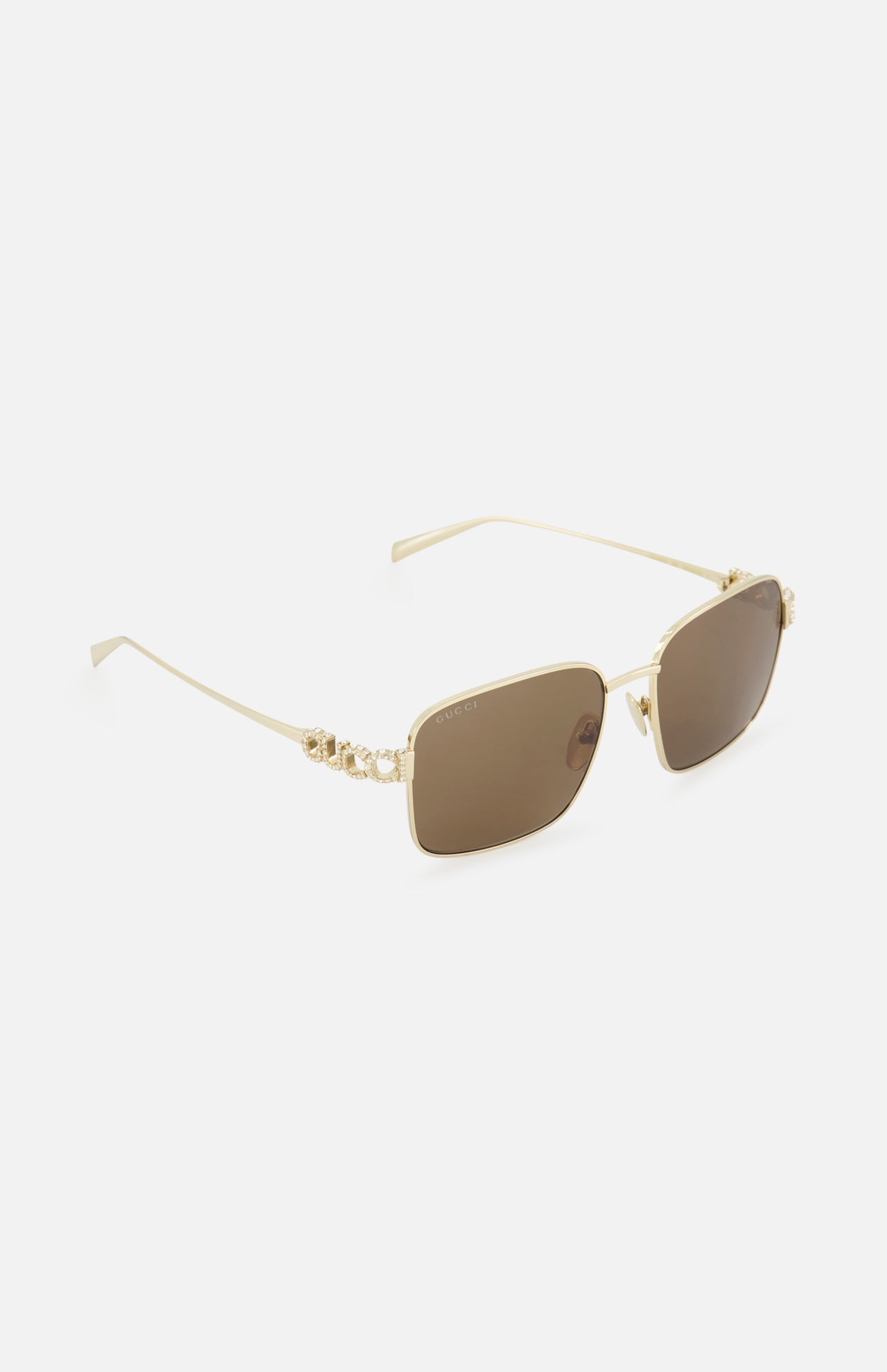 Gucci Square Gold Sunglasses by GUCCI feature gold-rimmed square metal frames, brown lenses, and decorative floral temple details. Minimalist style shown on a plain white background.