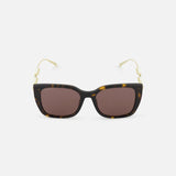 GUCCI Brown Tortoiseshell Sunglasses with brown lenses and gold temples adorned with pearl accents, shown on a plain white background.
