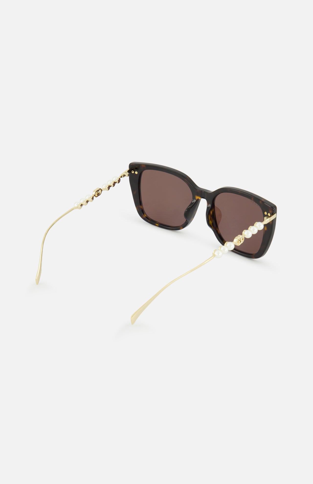 Gucci Brown Tortoiseshell Sunglasses featuring a butterfly frame with gold-toned temples embellished with pearls and logos.