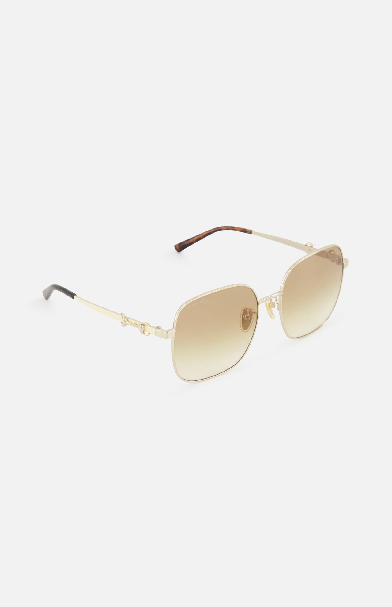 Gucci Rectangle Gold Sunglasses by GUCCI feature a gold rectangular frame, brown gradient lenses, and thin temples, shown on a white background.