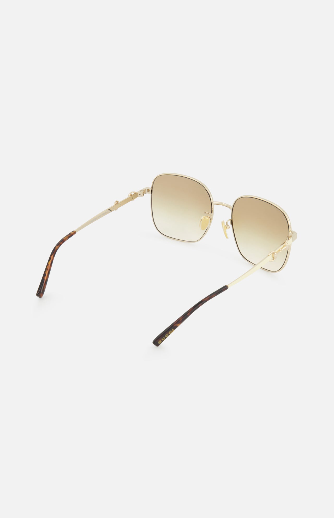 Gucci Rectangle Gold Sunglasses by GUCCI feature a gold rectangular frame, brown gradient lenses, thin arms, and dark brown tips, elegantly displayed on a white background.