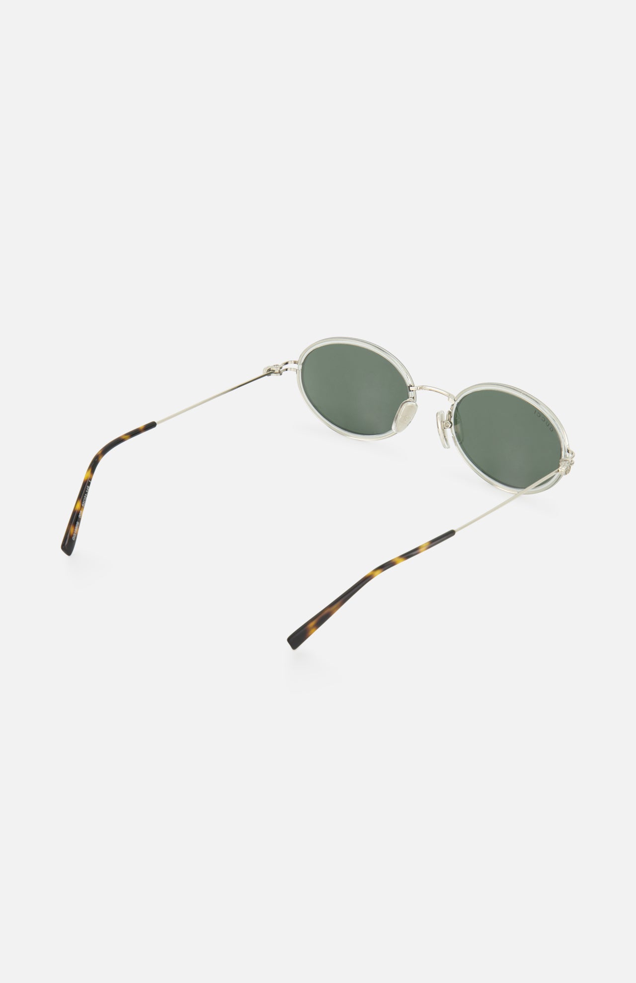 Gucci Oval Metal Sunglasses by GUCCI with thin silver frames, green lenses, and slender arms featuring tortoiseshell-patterned tips, shown on a white background.