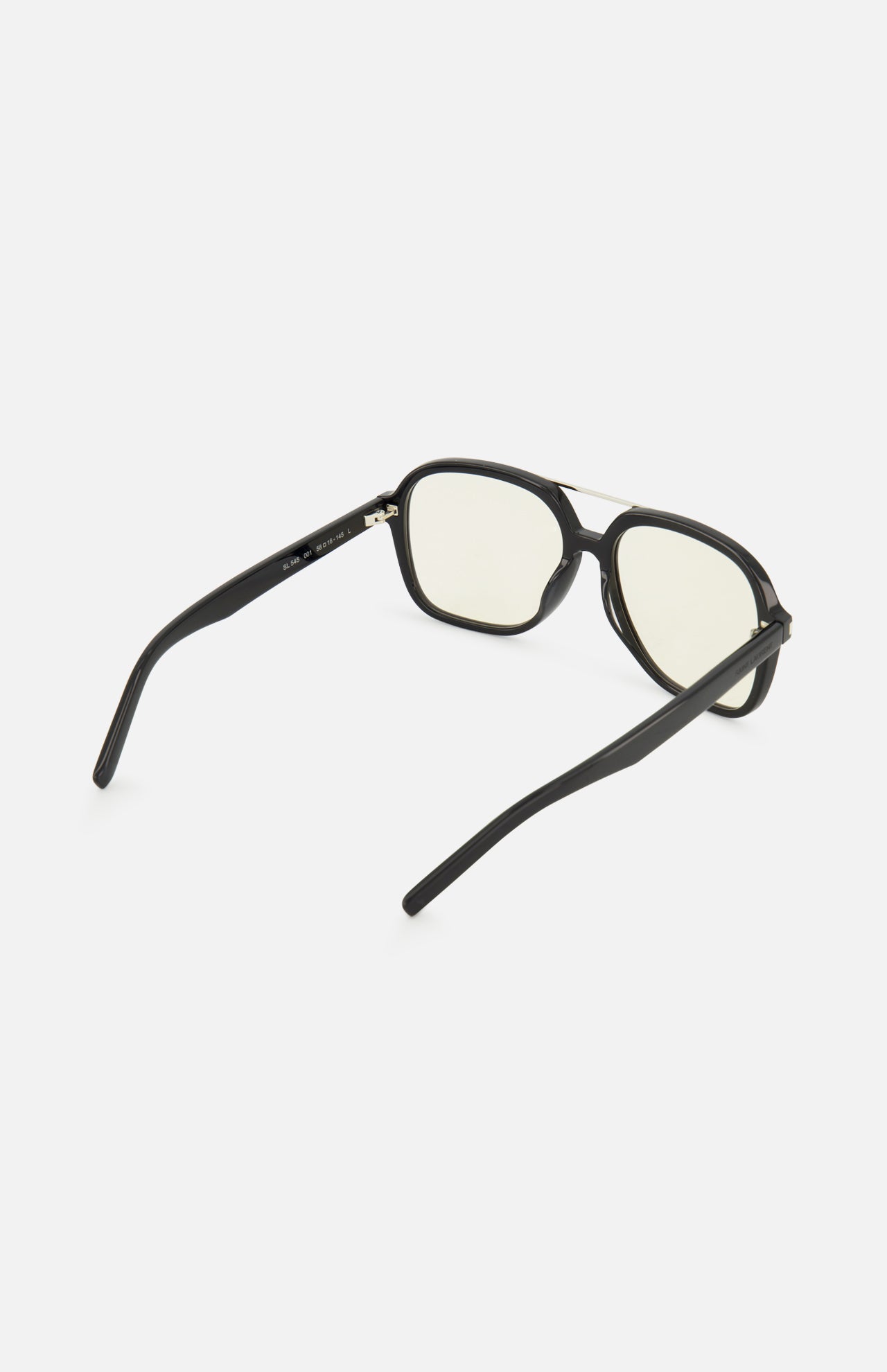 The YSL Aviator Black Sunglasses by YVES SAINT LAURENT feature retro-inspired black frames and slightly yellow-tinted lenses, displayed from the back with both arms extended against a plain white background.