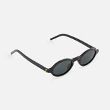 YSL Round Black Sunglasses by YVES SAINT LAURENT feature dark lenses and thin arms in a minimalist design, showcased on a white background at a slight angle.