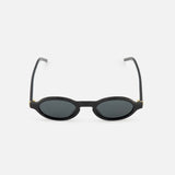 YSL Round Black Sunglasses by YVES SAINT LAURENT shown on a plain white background, featuring dark lenses, thin arms, and a minimalist round design.
