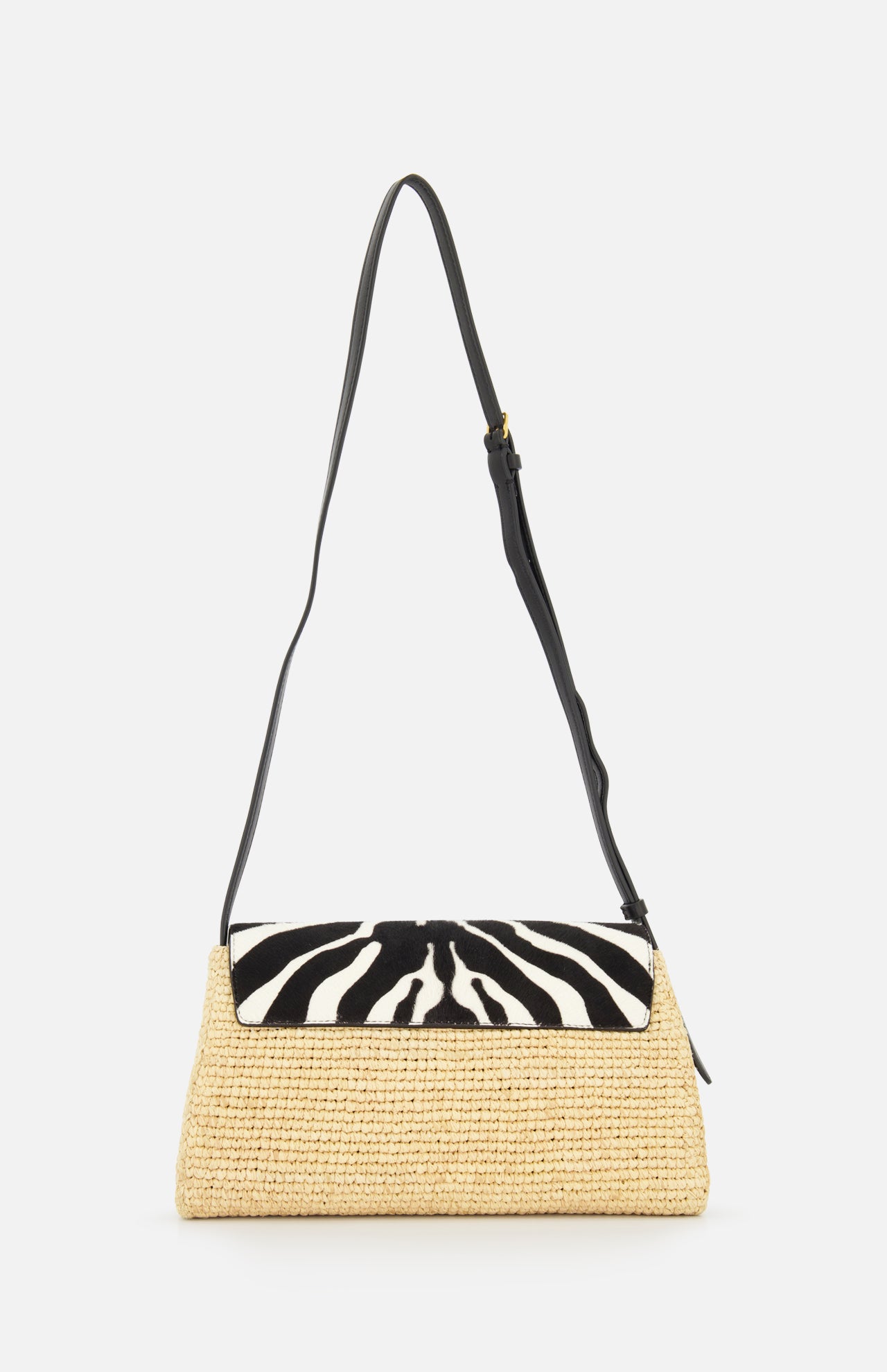 The KHAITE Audrey Raffia Crossbody Bag features handwoven Madagascar raffia, a black adjustable strap, and a flap with a striking black and white animal print motif.