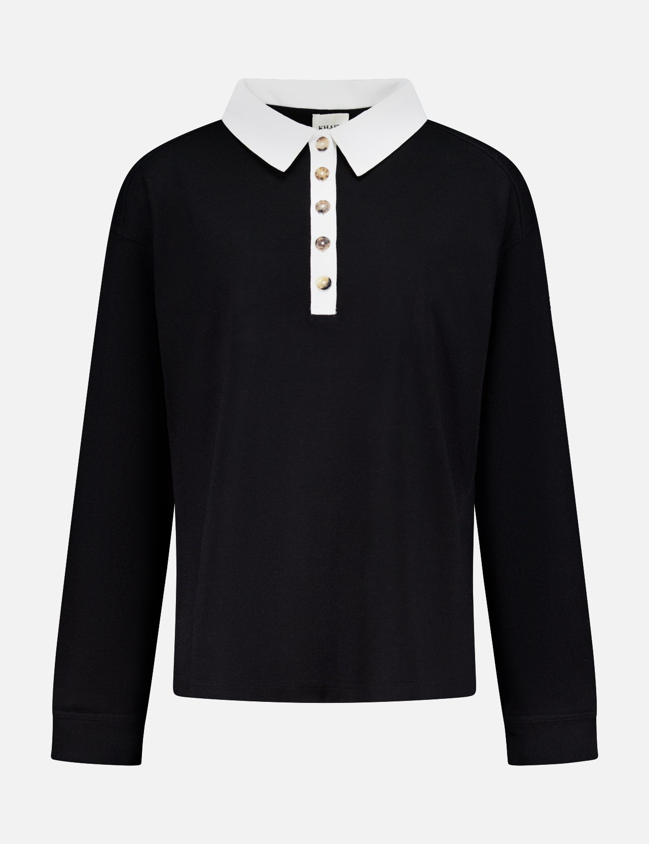 The Faithful Vintage Rugby Top by KHAITE is a unisex, long-sleeve black silk polo with a white collar and five-button placket, crafted from organic Japanese silk and shown on a plain white background.