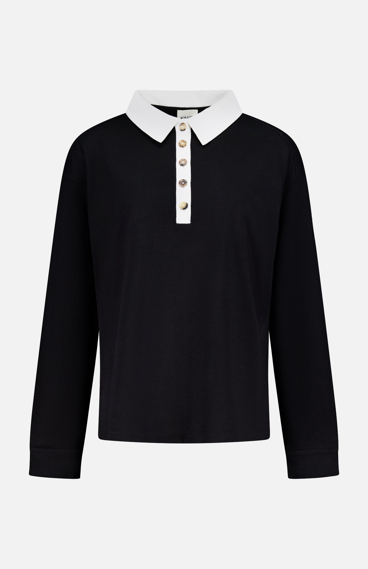 The Faithful Vintage Rugby Top by KHAITE is a unisex, long-sleeve black silk polo with a white collar and five-button placket, crafted from organic Japanese silk and shown on a plain white background.