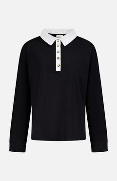 The Faithful Vintage Rugby Top by KHAITE is a unisex, long-sleeve black silk polo with a white collar and five-button placket, crafted from organic Japanese silk and shown on a plain white background.