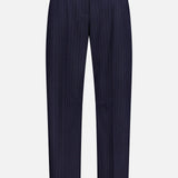 The KHAITE Jude Striped Wool-blend Pant features thin white pinstripes on navy, a button waist closure, and straight legs—ideal for a minimalist, classic look. Shown against a plain white background.