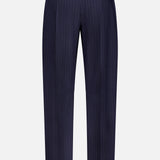 The KHAITE Jude Striped Wool-blend Pant features a navy pinstripe, tailored fit, flat front, and a single right buttoned pocket—ideal for minimalist wardrobes with timeless style.