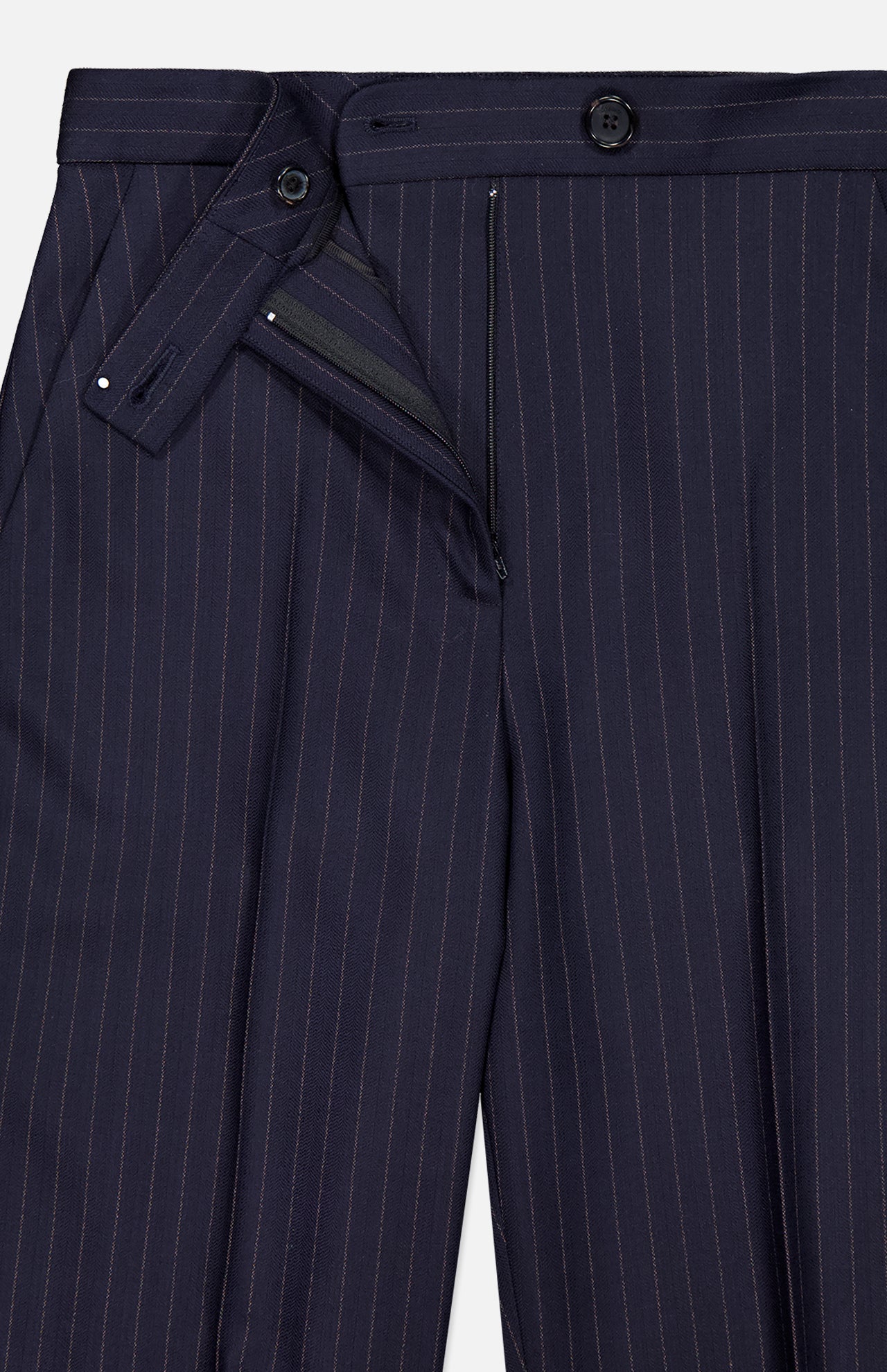 A close-up of KHAITE's Jude Striped Wool-blend Pant in navy, highlighting its pinstripes, front fly with button and zipper closure, and button-tab waistband—ideal for a timeless, minimalist look.