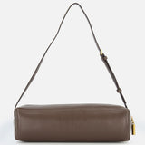 The Kye Patent Leather Shoulder Bag by KHAITE is a brown, rectangular handbag with an adjustable strap and gold zipper pull, crafted from patent leather and displayed against a plain white background.