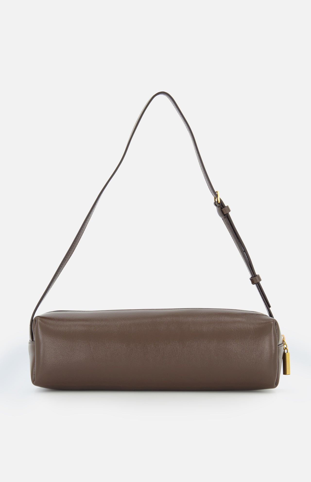 The Kye Patent Leather Shoulder Bag by KHAITE is a brown, rectangular handbag with an adjustable strap and gold zipper pull, crafted from patent leather and displayed against a plain white background.