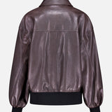 Back view of the KHAITE Shelman Leather Bomber Jacket in dark brown with a pointed collar, relaxed fit, and black ribbed cuffs and waistband, shown against a plain light background.