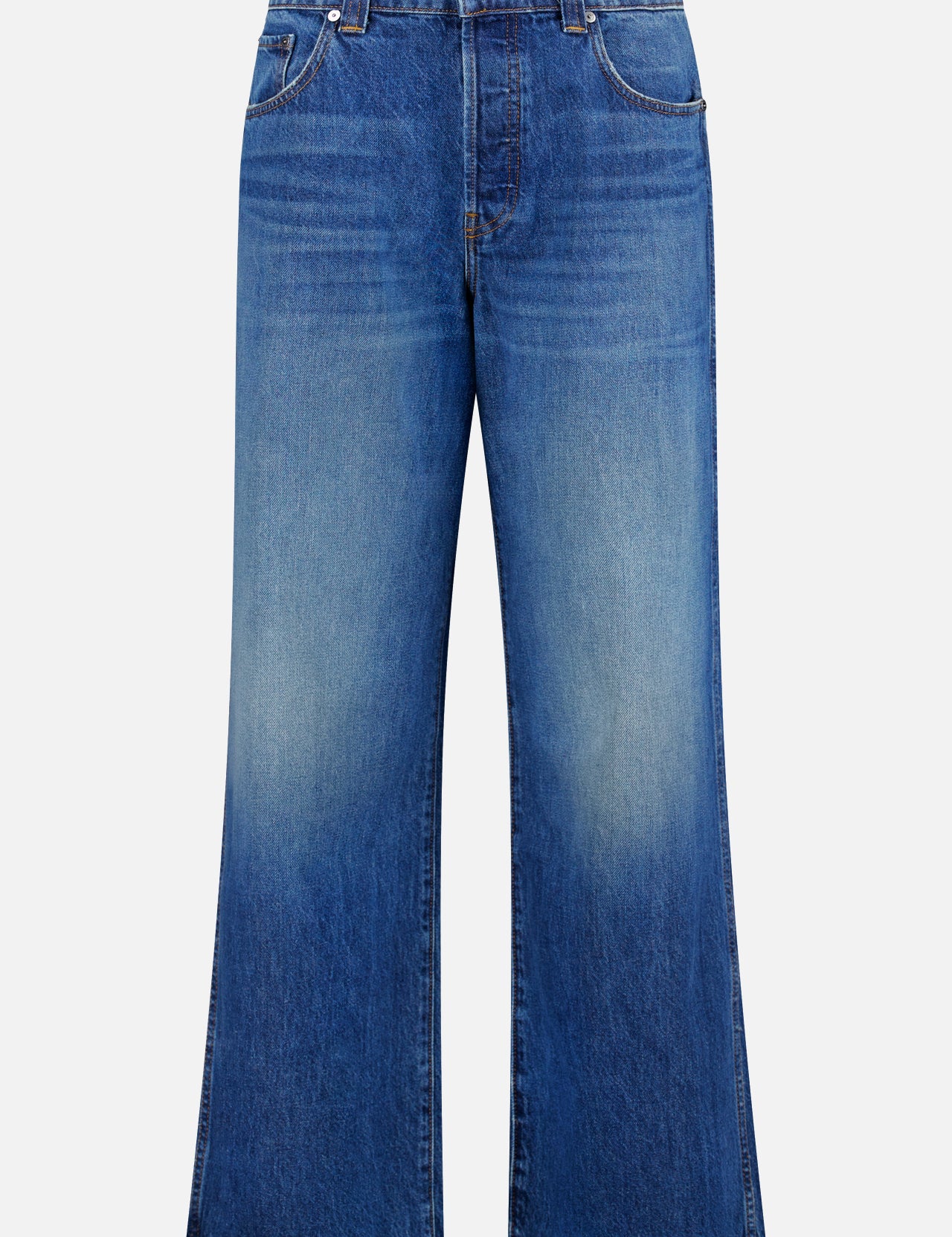 The Winslow Oversized Wide Leg Jean by KHAITE features a high waist, wide-leg silhouette, medium wash denim with subtle faded detail, front and back pockets, and a button-zip closure for classic vintage appeal.