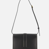 The KHAITE Blake Leather Crossbody Bag showcases Italian craftsmanship in black leather, a rectangular shape, adjustable strap, and front flap. "KHAITE" is embossed in gold at the bottom center, set against a plain white background.