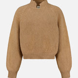 The KHAITE Cain Split Neck Cashmere Sweater, shown in tan with long sleeves and ribbed cuffs, hem, and collar, is crafted in Italian cashmere and displayed against a plain white background—an ideal addition to any minimalist wardrobe.