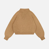 The KHAITE Cain Split Neck Cashmere Sweater—a brown, long-sleeve knit crafted from lightweight cashmere and featuring a ribbed mock neck, cuffs, and hem—makes an ideal addition to any minimalist wardrobe. Shown here laid flat on a white background.