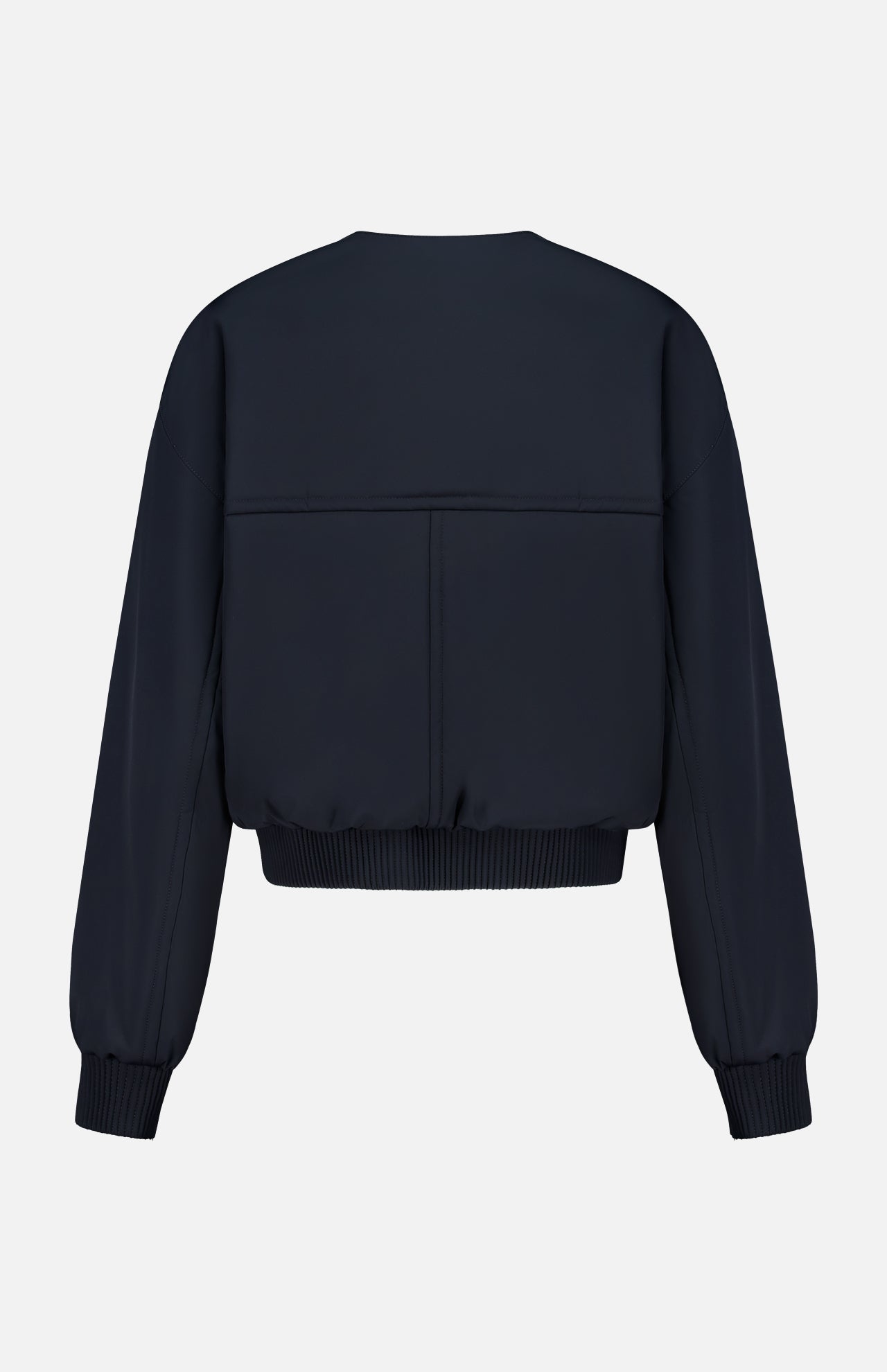 Back view of the KHAITE Cordan Cropped Bomber Jacket in dark navy blue nylon, featuring ribbed cuffs and waistband, displayed against a white background—a sleek option for a minimalist wardrobe.