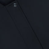Close-up of the KHAITE Cordan Cropped Bomber Jacket in black, featuring a snap button and a visible KHAITE label in the top left corner—a perfect addition to any minimalist wardrobe.