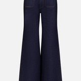 The Delmonico Wide Leg Jean in Benson by KHAITE features a dark wash, high waist, wide flared leg, visible back pockets, and contrast stitching, shown from the back on a plain white background.