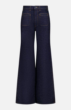 The Delmonico Wide Leg Jean in Benson by KHAITE features a dark wash, high waist, wide flared leg, visible back pockets, and contrast stitching, shown from the back on a plain white background.