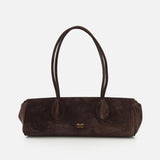 The Donna Soft Handbag by KHAITE is expertly crafted in Italy from dark brown suede. It features two long shoulder straps, rounded handles, and a rectangular silhouette. The front is adorned with the KHAITE brand name printed in small gold lettering.
