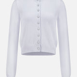 The KHAITE Everheart Suede Button Cardigan is a light purple, long-sleeved piece with a round neckline, ribbed details, and large matching buttons—ideal for a minimalist wardrobe.