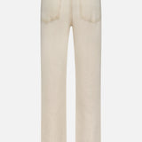Back view of KHAITE’s Finley Jean in Dumas: light beige, stretch-free denim jeans with straight legs, two rear pockets, and a black rectangular waistband label, shown against a plain white background.