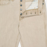 The Finley Jean in Dumas by KHAITE is crafted from stretch-free beige denim, features silver fly buttons, reveals its inside label and pocket lining, and is designed in a classic five-pocket, timeless mid-rise cut.